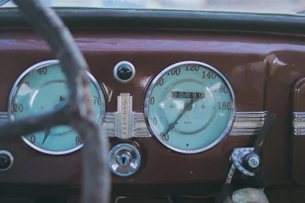 Vintage car dashboard with analog dials and gauges