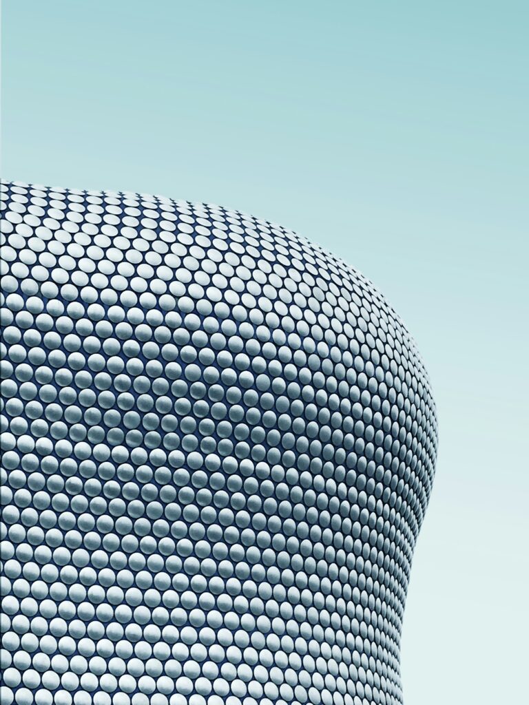 Iconic building design featuring circular patterns on the exterior, representing Birmingham's modern architecture.