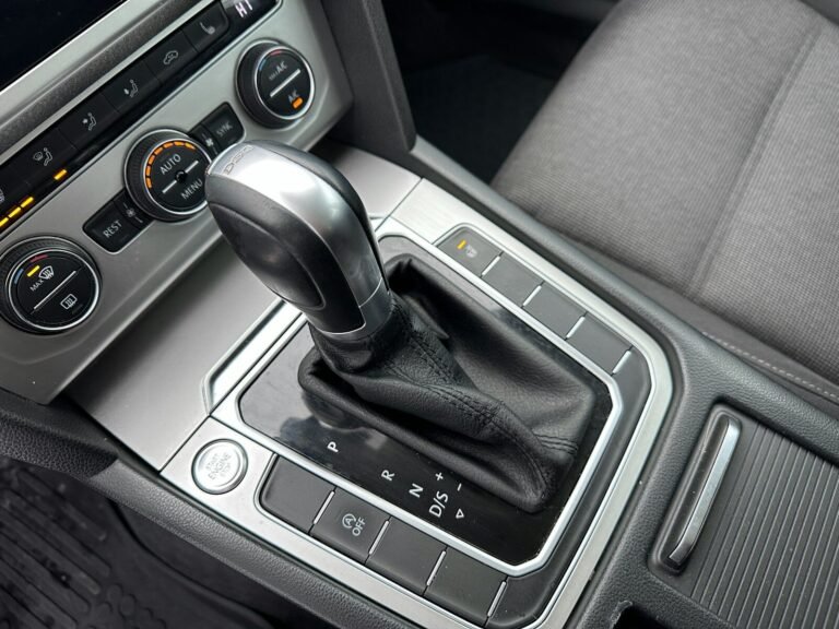 Close-up of an automatic car gear shift and dashboard controls