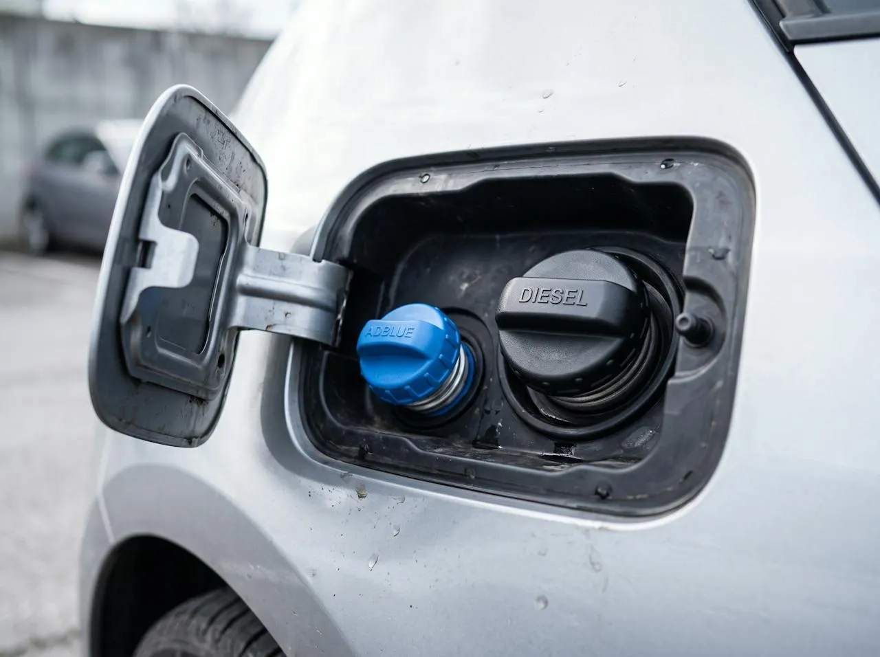 An AdBlue filler cap next to the diesel cap